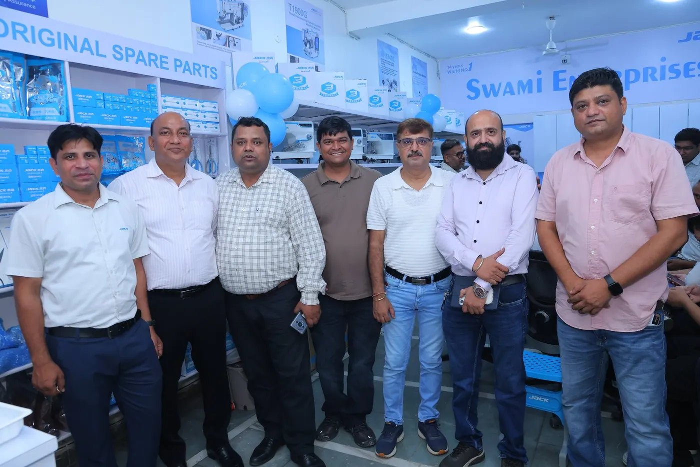 The Swami Enterprises team in the showroom, in front of the JACK original spare parts shelves